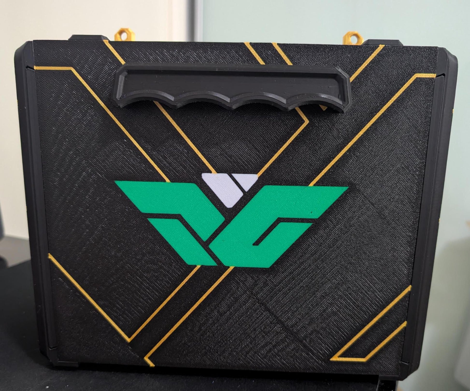 Layered Industries miniatures carrying case in black and green with a sturdy handle