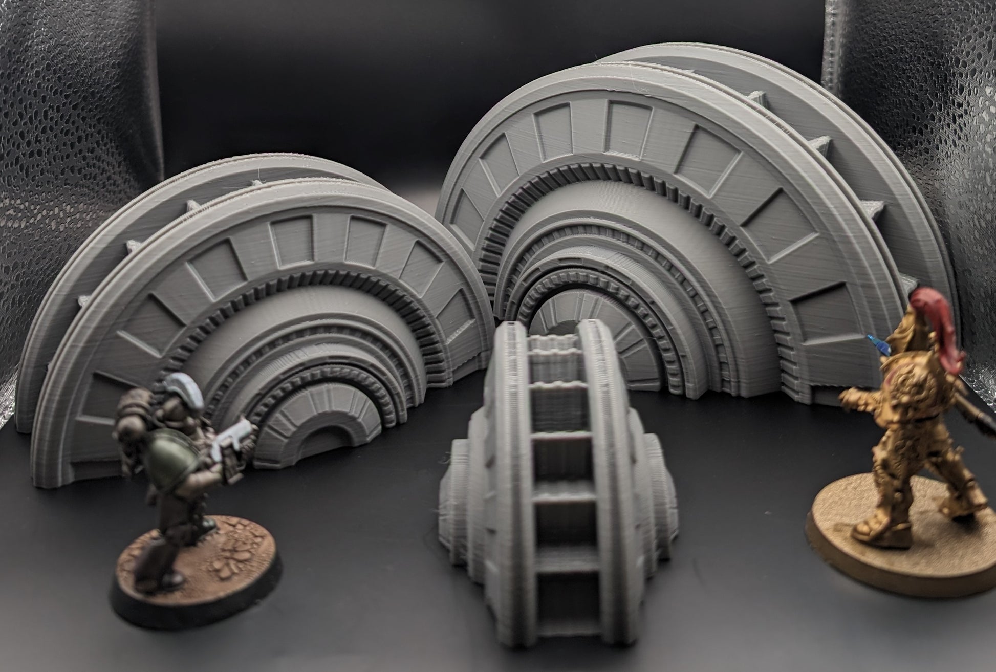 Layered Industries industrial sci-fi terrain accessories including detailed curved structures for wargaming