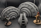 Layered Industries industrial sci-fi terrain accessories including detailed curved structures for wargaming