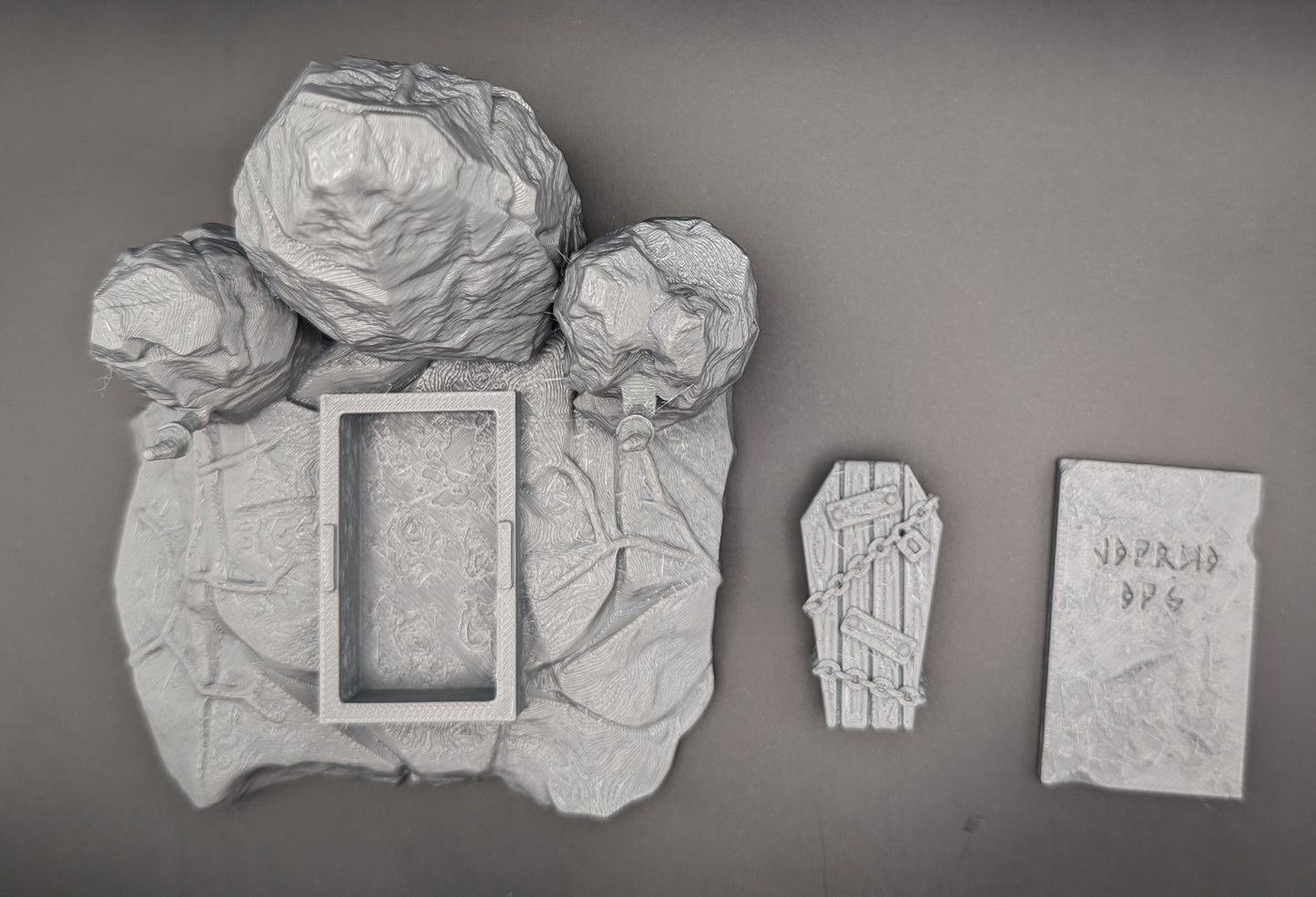 Layered Industries Wargame Terrain Set featuring rocky formations and a textured base for tabletop gaming