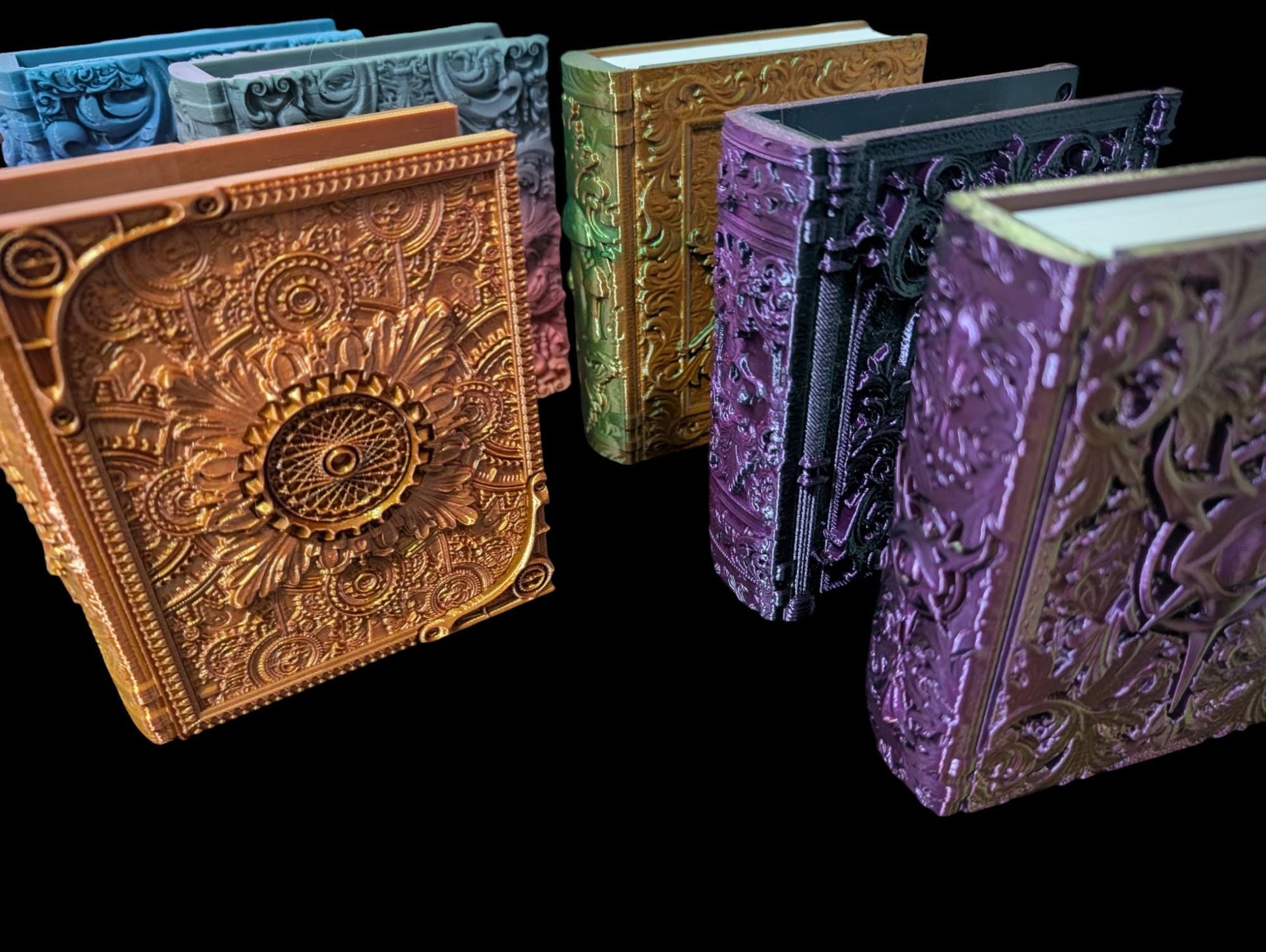 Assorted large RPG dice boxes from Layered Industries in intricate designs and vibrant colors